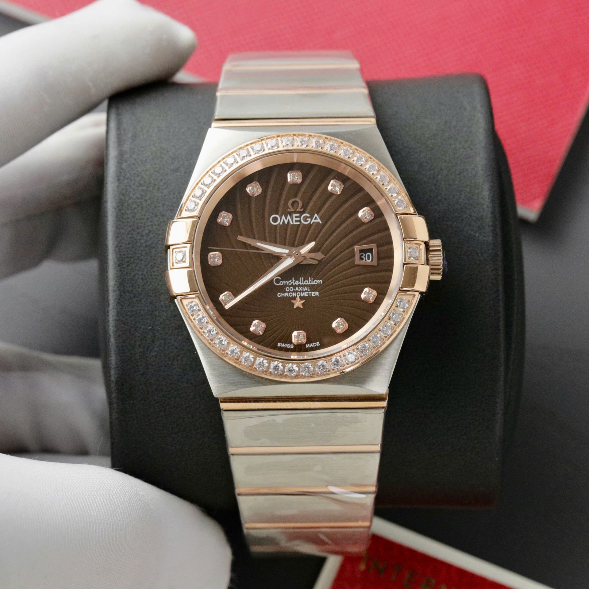 Dong-Ho-Omega-Constellation-Co-Axial-Fake-11-Demi-Vang-Hong-Mat-Nau-38mm-2.jpg Omega Constellation Co-Axial Fake Watch Brown Dial Metal Strap 38mm - Image 1