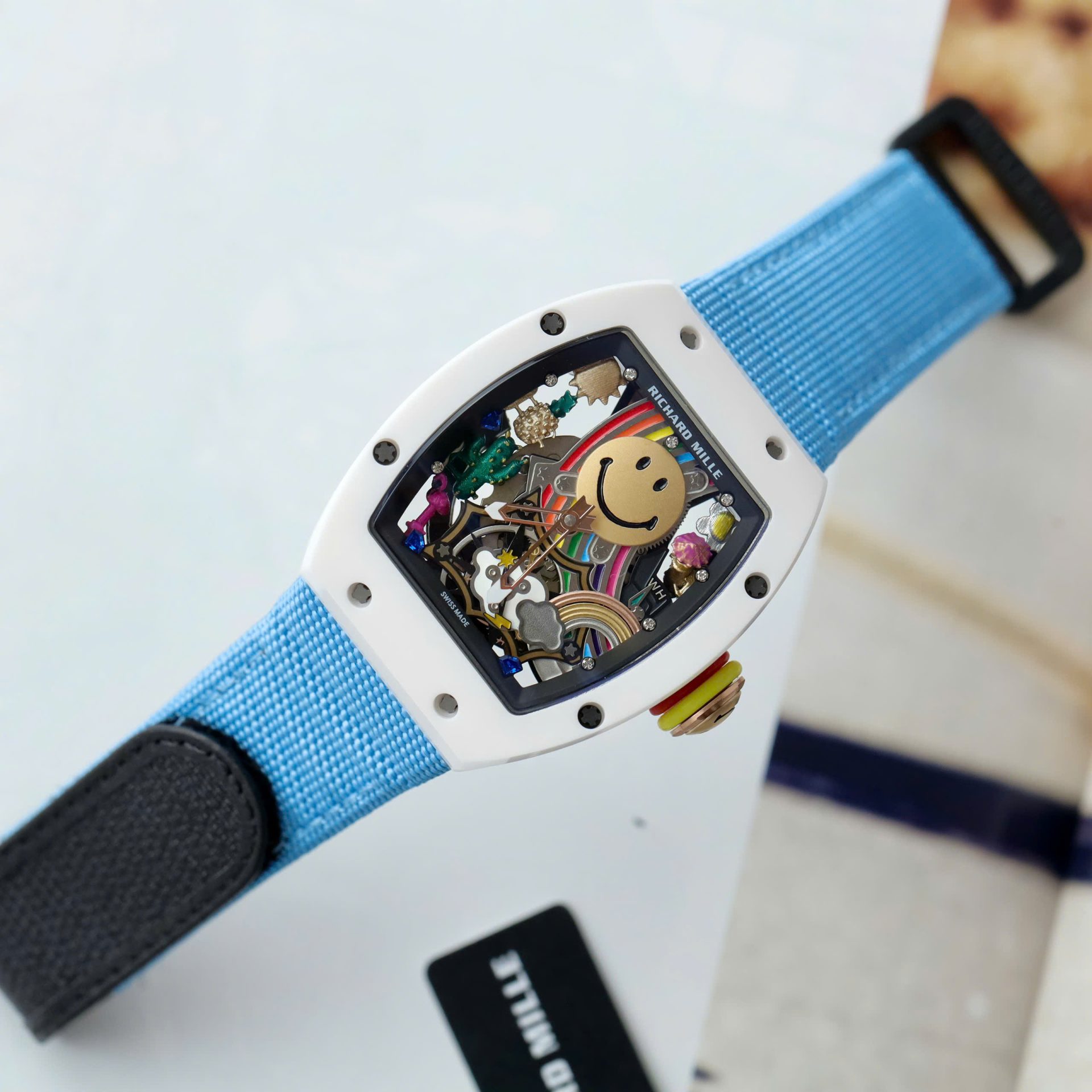 Dong-Ho-Richard-Mille-Rep-11-Cao-Cap-RM88-Smiley-Day-Vai-Nato-Mau-Xanh-42mm-4.jpg Richard Mille Copies Watches RM88 Smiley Fabic Nato Strap Blue 42mm - Image 1